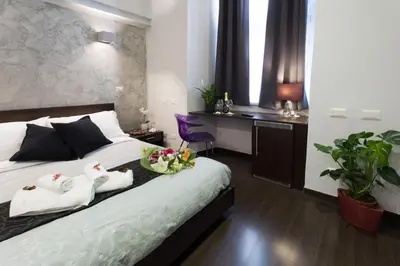 a hotel room with a bed with two swans on it at Chroma Italy - Chroma Pente in Rome