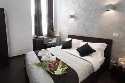 a bedroom with a bed with a tray of flowers on it at Chroma Italy - Chroma Pente in Rome