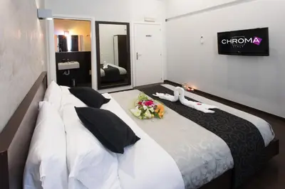 a hotel room with a bed with flowers on it at Chroma Italy - Chroma Pente in Rome