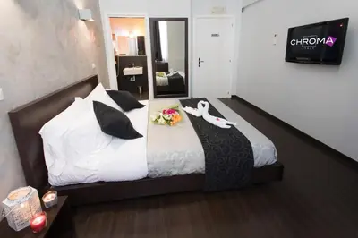a bedroom with a bed with flowers and a swan on it at Chroma Italy - Chroma Pente in Rome