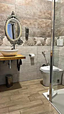 a bathroom with a sink and a toilet and a mirror at In the Center by Local Domus in Rome