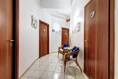 a corridor with a chair and a table in a hallway at In the Center by Local Domus in Rome