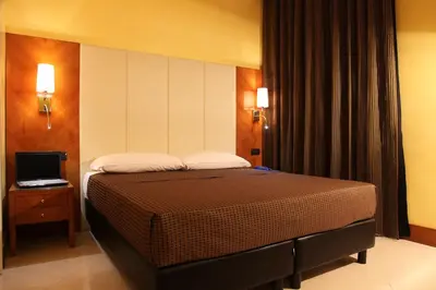 a bedroom with a bed and a laptop on a table at Federica's Home in Rome