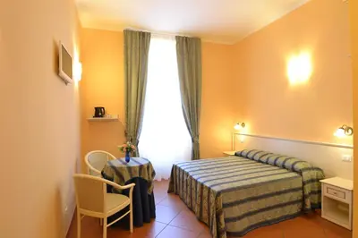 a hotel room with a bed and a window at Vatican Town in Rome