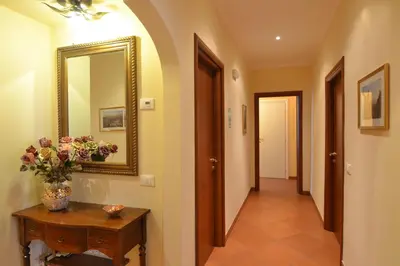 a hallway with a mirror and a table with flowers at Vatican Town in Rome