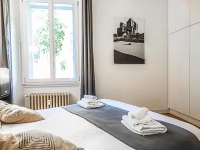 a bedroom with a bed with towels on it at Mecenate Rooms in Rome
