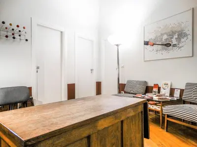 a living room with a table and chairs at Mecenate Rooms in Rome