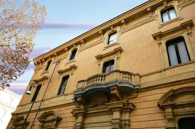 a building with a balcony on the side of it at Villa Spalletti Trivelli - Small Luxury Hotels of the World in Rome