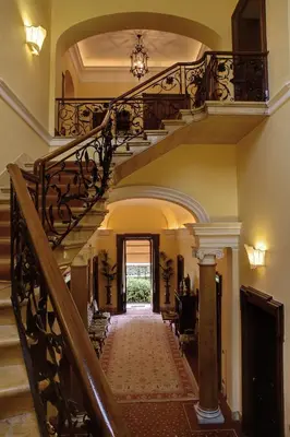 a hallway with a spiral staircase in a house at Villa Spalletti Trivelli - Small Luxury Hotels of the World in Rome