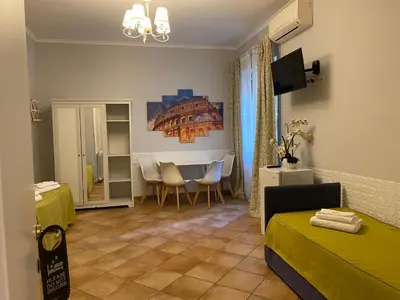 a room with a bed and a table with chairs at Domus Prati in Rome