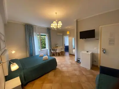 a hotel room with a bed and a living room at Domus Prati in Rome