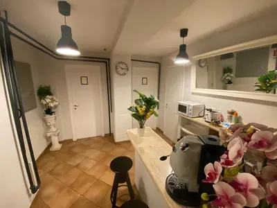 a kitchen with a counter with flowers on it at Domus Prati in Rome