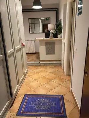 a hallway with a blue rug on the floor at Domus Prati in Rome