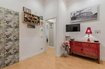 a room with a dresser and a tv on a wall at Casa Fabio in Rome