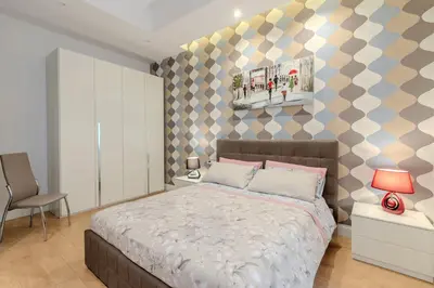 a bedroom with a bed and a geometric wall at Casa Fabio in Rome