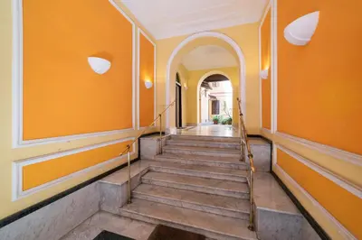 an orange hallway with stairs in a house at Casa Fabio in Rome
