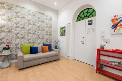 a living room with a couch with colorful pillows at Casa Fabio in Rome