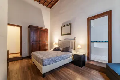 a bedroom with a bed and a large window at GuestHost - Pantheon Charming Apartment in Rome