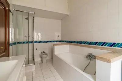 a white bathroom with a tub and a toilet at GuestHost - Pantheon Charming Apartment in Rome