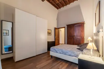 a bedroom with a large bed and a dresser at GuestHost - Pantheon Charming Apartment in Rome