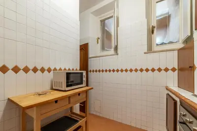 a bathroom with a microwave on a wooden table at GuestHost - Pantheon Charming Apartment in Rome