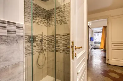 a bathroom with a shower with a glass door at Feronia Guest house in Rome
