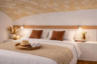 a bedroom with a white bed with towels on it at Tolli Colosseo Apartment in Rome