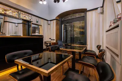 a bar with tables and chairs in a room at Relais Orso in Rome