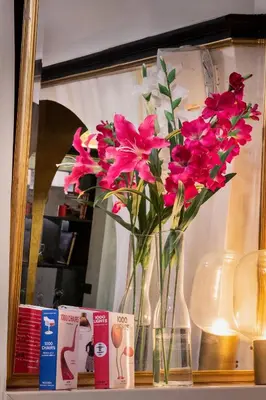 a vase filled with pink flowers sitting on a shelf at Relais Orso in Rome