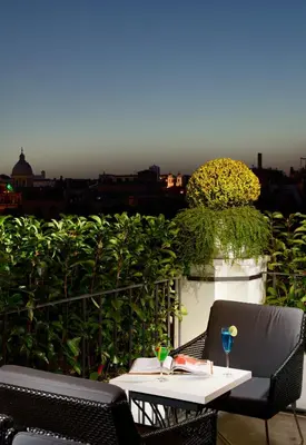 a table and chairs on a balcony with a view at Relais Orso in Rome