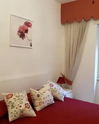 a bedroom with a bed with pillows on it at Asher's House Colosseum in Rome