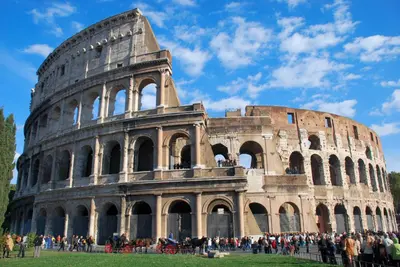 a group of people standing in front of the coliseum at Asher's House Colosseum in Rome