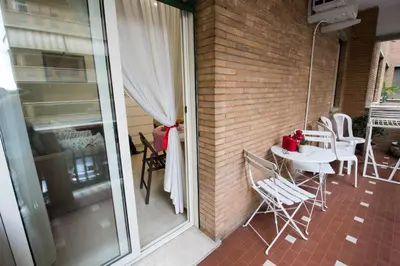 a balcony with a table and chairs on a patio at Asher's House Colosseum in Rome