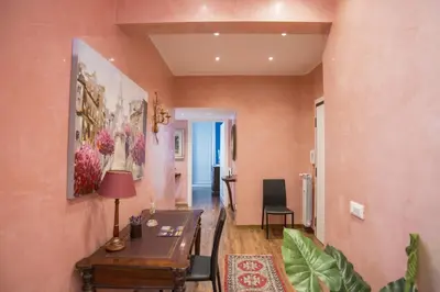 a living room with a table and a dining room at Stradivari Luxury Apartment in Rome