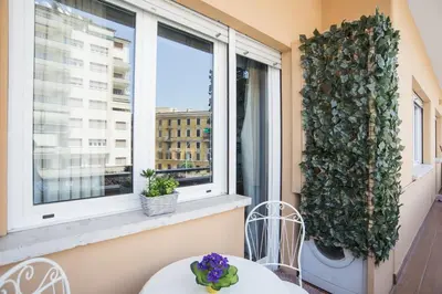 a table and chairs on a balcony with a window at Stradivari Luxury Apartment in Rome