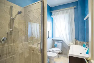 a bathroom with a shower and a toilet and a sink at Stradivari Luxury Apartment in Rome