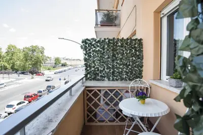 a balcony with a table and a window with a view of a street at Stradivari Luxury Apartment in Rome