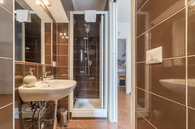a bathroom with a sink and a shower at Be My Guest in Rome
