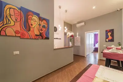 a living room with a painting on the wall at Be My Guest in Rome