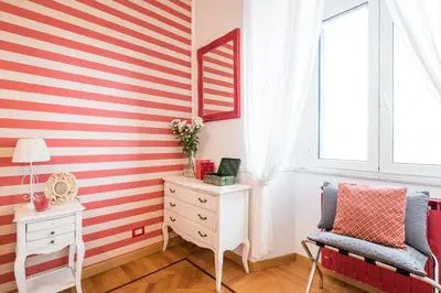 a room with a red and white striped wall at Suite 06 in Rome
