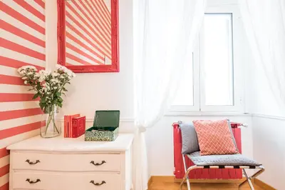 a room with a dresser and a flag painted on the wall at Suite 06 in Rome