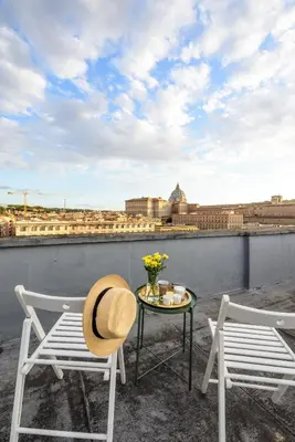 two chairs and a table with a hat on a roof at Suite 06 in Rome