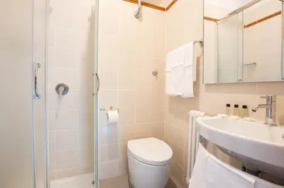 a bathroom with a toilet and a sink at Hotel Trastevere in Rome