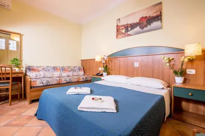 a hotel room with a bed and a couch at Hotel Trastevere in Rome