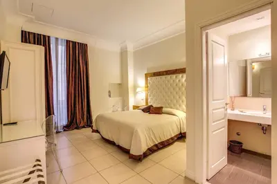 a hotel room with a bed and a sink at Caput Mundi Suite in Rome