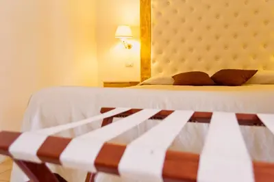 a bed in a room with a large mirror at Caput Mundi Suite in Rome