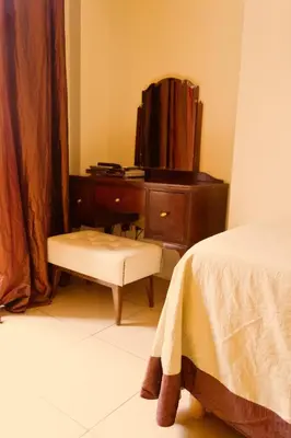a bedroom with a dresser and a bed and a stool at Caput Mundi Suite in Rome