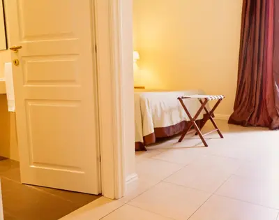 a door leading into a room with a bed at Caput Mundi Suite in Rome