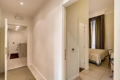 a hallway with a room with a bed and a mirror at Caput Mundi Suite in Rome