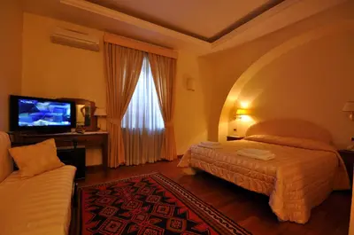 a hotel room with a bed and a flat screen tv at Casale De Santis in Rome